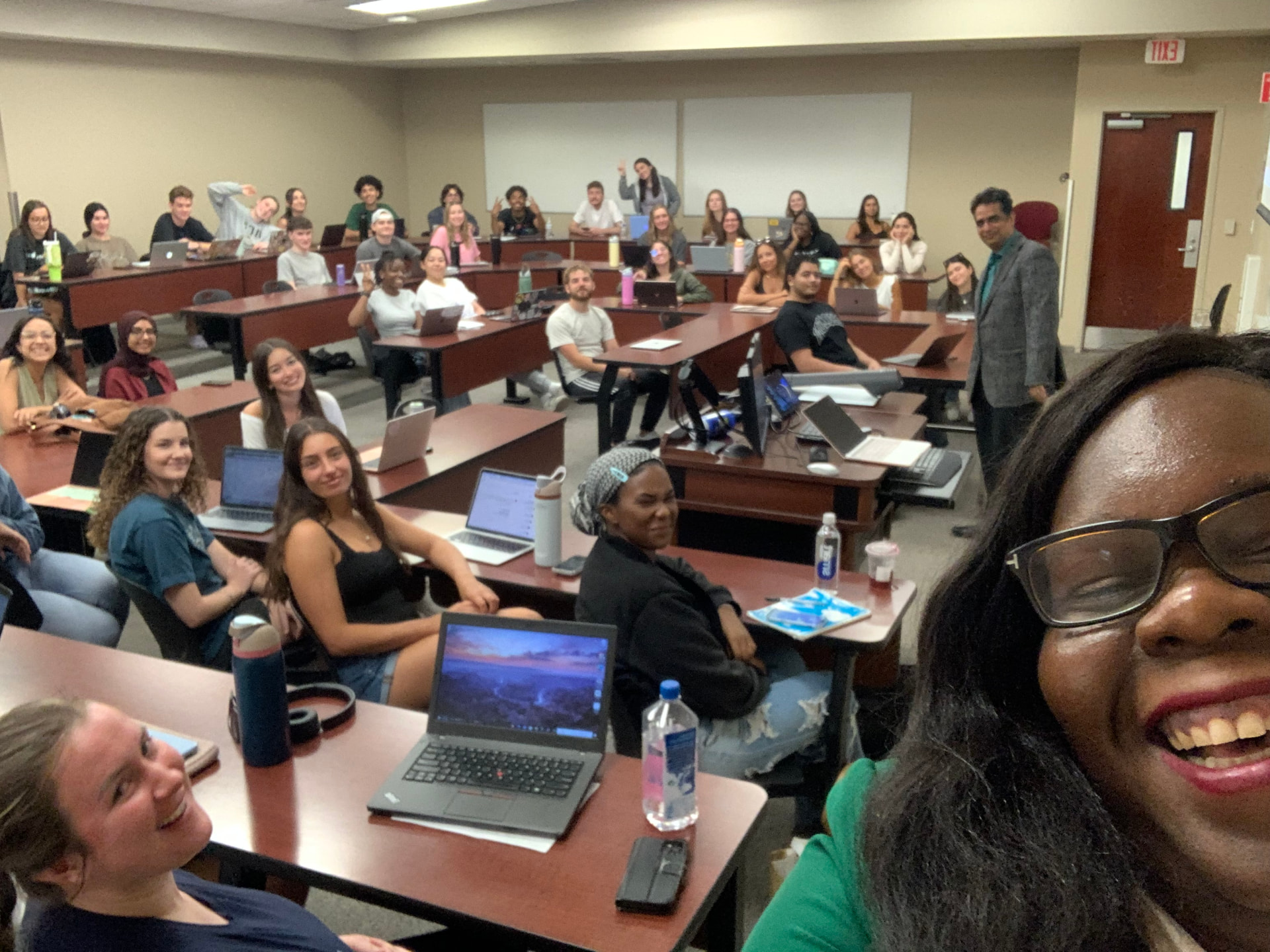 Marline Paul taking a selfie with a full university classroom after an AI session