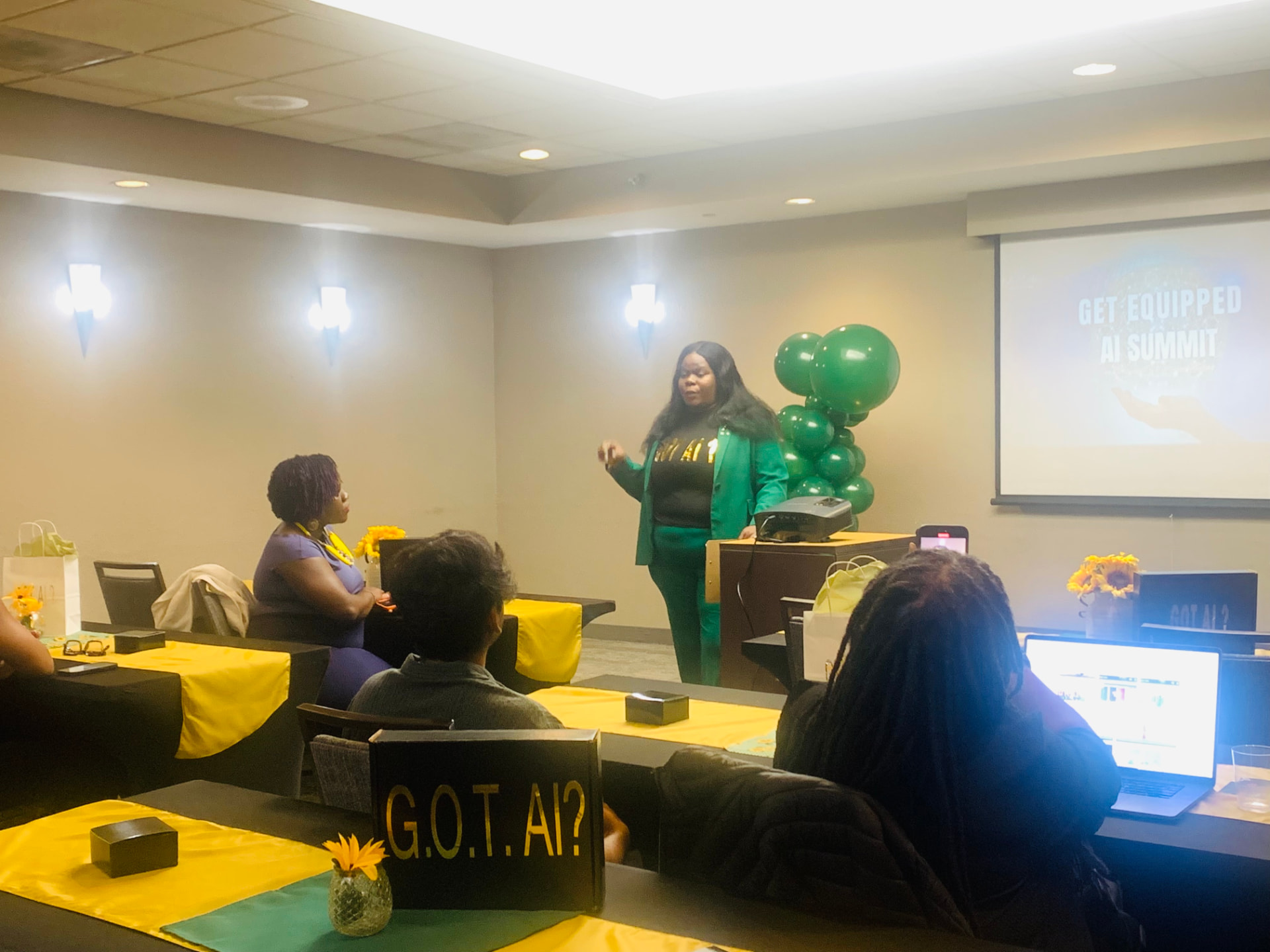 Marline Paul presenting at the Get Equipped AI Summit in a green suit, with attendees seated at decorated tables