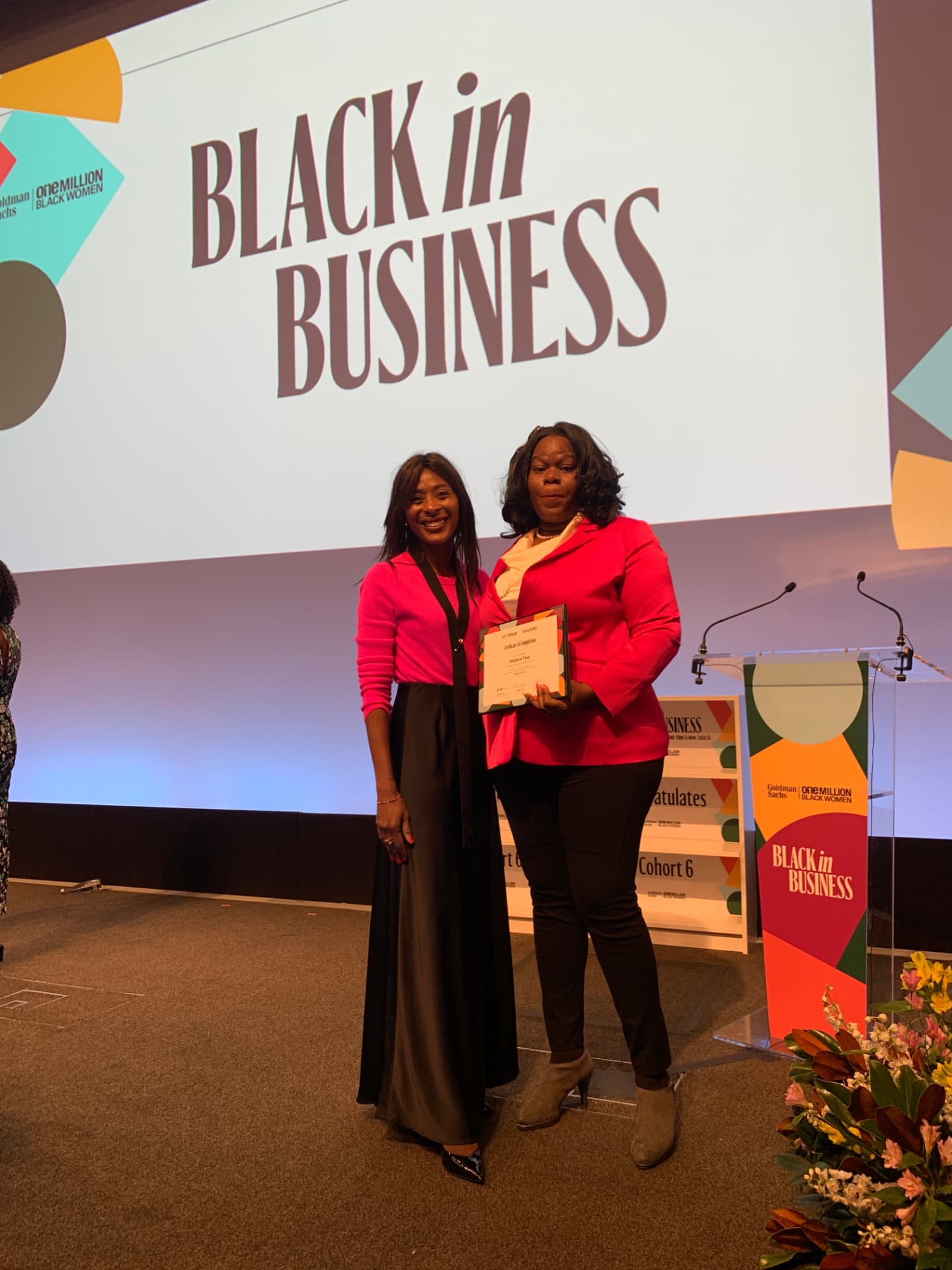 Marline Paul receiving her Goldman Sachs One Million Black Women Black in Business certificate on stage